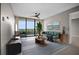Bright staged living room featuring a ceiling fan and sliding glass doors to a balcony with verdant views at 3211 W Swann Ave # 808, Tampa, FL 33609