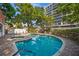 Community pool featuring lounge chairs, mature trees, and access to hot tub at 3211 W Swann Ave # 808, Tampa, FL 33609