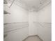 Spacious walk-in closet with built-in shelving and neutral tiling at 3211 W Swann Ave # 808, Tampa, FL 33609