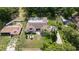 Aerial view of the home showing the roof, screened pool, and surrounding greenery at 4301 Hudson Ln, Tampa, FL 33618