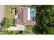Aerial view of the home featuring the rooftop, pool, driveway, and surrounding landscape at 4301 Hudson Ln, Tampa, FL 33618
