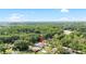 Aerial view showcases the house with a pool amidst a lush, green landscape at 4301 Hudson Ln, Tampa, FL 33618