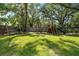 Serene backyard featuring a swing set and playset, perfect for Gathering fun and outdoor activities at 4301 Hudson Ln, Tampa, FL 33618