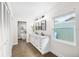 Modern bathroom featuring a double vanity, sleek fixtures, and a soaking tub at 4301 Hudson Ln, Tampa, FL 33618