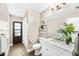 Bathroom with a marble countertop sink, wall shelves, and shower over tub at 4301 Hudson Ln, Tampa, FL 33618