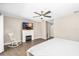 Bedroom featuring a fireplace, rocker, and hardwood flooring at 4301 Hudson Ln, Tampa, FL 33618