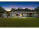Inviting single-story home featuring manicured lawn, mature trees, and beautiful landscaping, providing great curb appeal at 4301 Hudson Ln, Tampa, FL 33618