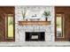 Close-up of stone fireplace with a wood mantel, decorative mirror, and stylish accents at 4301 Hudson Ln, Tampa, FL 33618