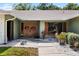 Inviting double-door front entrance featuring decorative wreaths, mature landscaping, and a well-maintained walkway and lawn at 4301 Hudson Ln, Tampa, FL 33618