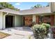 Inviting double-door front entrance featuring decorative wreaths, mature landscaping, and a well-maintained walkway and lawn at 4301 Hudson Ln, Tampa, FL 33618