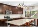 Beautiful kitchen features granite countertops, dark cabinetry, and a window overlooking the backyard at 4301 Hudson Ln, Tampa, FL 33618