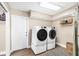 Functional laundry room featuring modern washer and dryer units, ample storage, and stylish flooring at 4301 Hudson Ln, Tampa, FL 33618