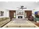 Spacious living room featuring a stone fireplace, wood accents, and comfortable furnishings at 4301 Hudson Ln, Tampa, FL 33618