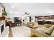 Open-concept living space featuring a stone fireplace, wood floors, and modern furnishings at 4301 Hudson Ln, Tampa, FL 33618