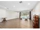 Bright living room with hardwood floors, leading to a screened-in patio and pool at 4301 Hudson Ln, Tampa, FL 33618