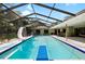 Inviting screened-in pool area with diving board, water slide, and a bar, perfect for summer fun at 4301 Hudson Ln, Tampa, FL 33618