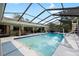 Beautiful screened-in pool area with a slide, outdoor seating, and lush surroundings for relaxation at 4301 Hudson Ln, Tampa, FL 33618