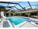 Amazing screened-in pool featuring a slide, diving board, outdoor seating and a lounge area, ideal for relaxation at 4301 Hudson Ln, Tampa, FL 33618