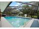 Stunning screened-in pool area, complete with a slide and basketball hoop, ideal for outdoor enjoyment at 4301 Hudson Ln, Tampa, FL 33618