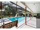 Gorgeous screened-in pool with a swing, poolside seating, and a serene backyard view, perfect for leisure at 4301 Hudson Ln, Tampa, FL 33618