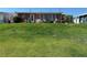 Spacious backyard with a grassy lawn and a patio set for outdoor entertaining at 29146 Tamayo Dr, Punta Gorda, FL 33982