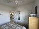 Bedroom featuring a bed with a patterned comforter, an open door, and a closet for storage at 29146 Tamayo Dr, Punta Gorda, FL 33982