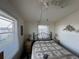 Bedroom featuring two windows for ample natural light, and a bed with a patterned comforter at 29146 Tamayo Dr, Punta Gorda, FL 33982