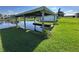 Private boat dock with covered slip, providing direct water access for boating and recreation at 29146 Tamayo Dr, Punta Gorda, FL 33982