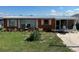 Charming single-story home with an easy-to-maintain lawn, a walkway, and a cozy porch with seating at 29146 Tamayo Dr, Punta Gorda, FL 33982