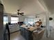 Open-concept living space with kitchen island, dining area, and comfortable seating, perfect for gatherings at 29146 Tamayo Dr, Punta Gorda, FL 33982
