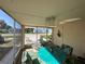 Bright sun room featuring dining furniture, natural light, and views of the surrounding neighborhood at 29146 Tamayo Dr, Punta Gorda, FL 33982