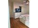 Bedroom featuring hardwood floors, a dresser, and a mounted television at 3124 Pond Hollow St # 183, Wesley Chapel, FL 33543