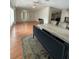 Open dining room with wood floors, a marble table and easy access to other rooms at 3124 Pond Hollow St # 183, Wesley Chapel, FL 33543