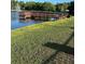Scenic view of the lake with a wooden dock that offers a tranquil spot for relaxation and enjoying the waterfront at 3124 Pond Hollow St # 183, Wesley Chapel, FL 33543