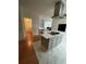 Modern kitchen island with cooktop with view into living spaces at 3124 Pond Hollow St # 183, Wesley Chapel, FL 33543