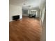 Spacious living room featuring wood floors that transition to a dining area with a ceiling fan for added comfort at 3124 Pond Hollow St # 183, Wesley Chapel, FL 33543