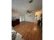 Inviting room featuring wood flooring, a ceiling fan, sliding glass doors, and built-in shelving at 3124 Pond Hollow St # 183, Wesley Chapel, FL 33543