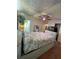 Bedroom features a floral bedspread, ample closet space and easy bathroom access at 3124 Pond Hollow St # 183, Wesley Chapel, FL 33543