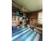 Organized storage area with shelves and a blue tarp on the floor at 3124 Pond Hollow St # 183, Wesley Chapel, FL 33543