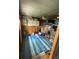 Organized storage area with shelves and a blue tarp on the floor at 3124 Pond Hollow St # 183, Wesley Chapel, FL 33543