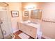 Elegant bathroom with a double vanity, marble countertop, framed mirrors, and a glass shower at 5169 Oxford Dr, Sarasota, FL 34242