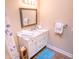 This bathroom has a white vanity, updated fixtures and a framed mirror at 5169 Oxford Dr, Sarasota, FL 34242