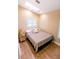 Cozy bedroom featuring a skylight, neutral tones, and hardwood floors at 5169 Oxford Dr, Sarasota, FL 34242