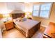 Cozy bedroom features a unique wicker bed frame, soft lighting, and tranquil decor at 5169 Oxford Dr, Sarasota, FL 34242