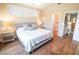The main bedroom has two windows with plantation shutters, and wood floors at 5169 Oxford Dr, Sarasota, FL 34242