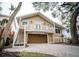 Two-story home featuring a balcony, stairs, a two car garage and a well-kept paved driveway at 5169 Oxford Dr, Sarasota, FL 34242