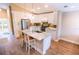 Bright kitchen featuring an island with seating, white cabinets, and stainless-steel appliances at 5169 Oxford Dr, Sarasota, FL 34242