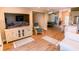 This coastal living room has wood floors, a large TV, and stylish furnishings at 5169 Oxford Dr, Sarasota, FL 34242