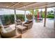 Inviting covered patio featuring comfortable seating, stylish furniture, and lush landscaping at 5169 Oxford Dr, Sarasota, FL 34242