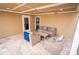 Inviting covered patio featuring comfortable wicker furniture and neutral tile flooring at 5169 Oxford Dr, Sarasota, FL 34242